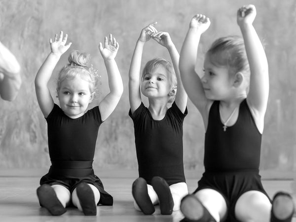 Ballet shoes and bodysuits on young dancers